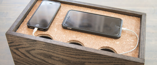 Charging station with two iPhones plugged into chargers