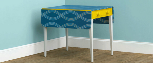 Colorful table with drawer in corner of a room