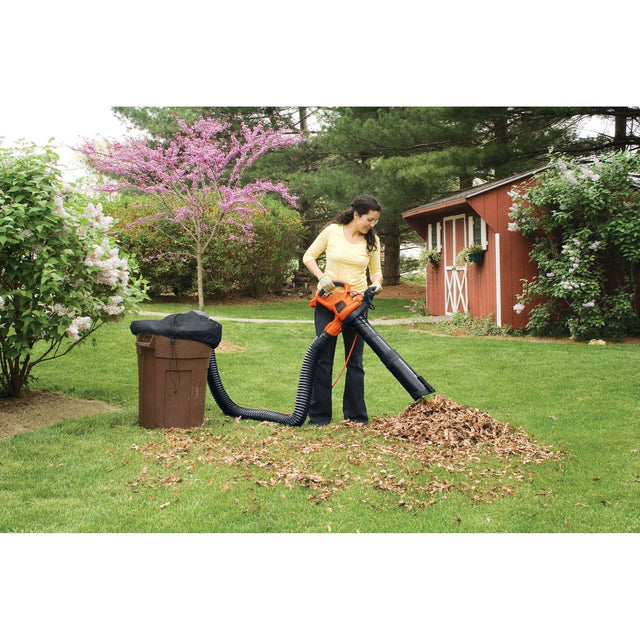 Woman using BLACK+DECKER leaf vacuum