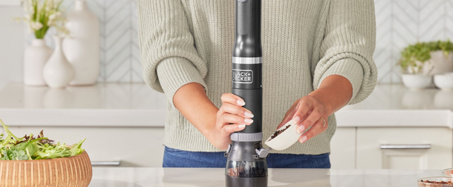 Talent adding peppercorns to the black, BLACK+DECKER kitchen wand spice grinder attachment