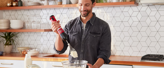 Talent using the red, BLACK+DECKER kitchen wand whisk to make whipped cream