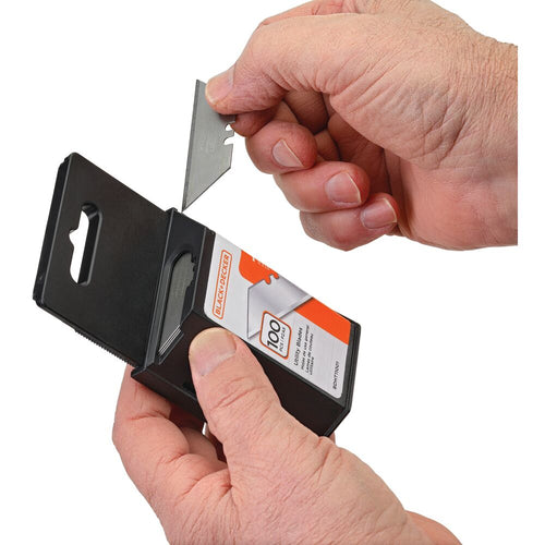 Black and decker utility knife blade being taken out of it's packaging that holds 100 utility knife blades