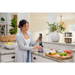 Front view of BLACK+DECKER kitchen wand 3in1 Cordless Kitchen multi-tool kit in grey featuring immersion blender, whisk and food chopper attachments