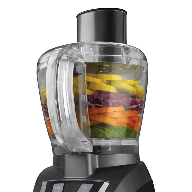 Close-up of 8 Cup Food Processor bowl with vegetables inside and on white background