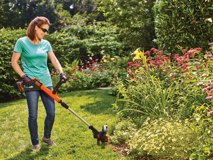Woman using BLACK+DECKER string trimmer