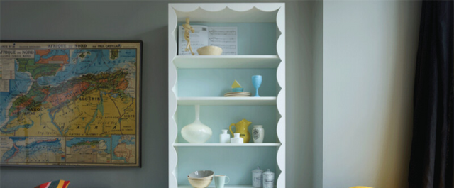 Shelf with scalloped frame against wall