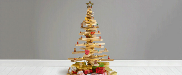 Wooden Christmas tree with miscellaneous decorations and gifts