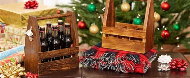 Wooden 6-pack holder on a table in front of a Christmas tree