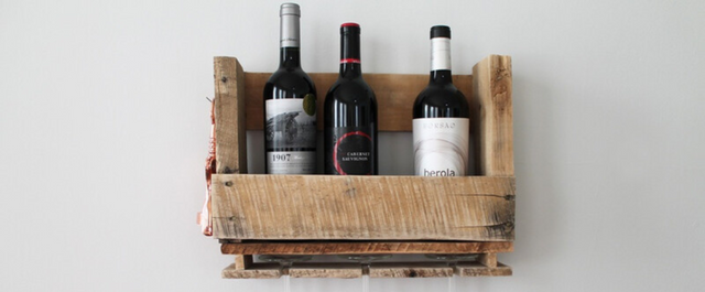 Wine rack full of bottles hanging on wall