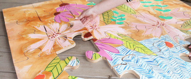 Large puzzle of flowers and textures being completed on the floor