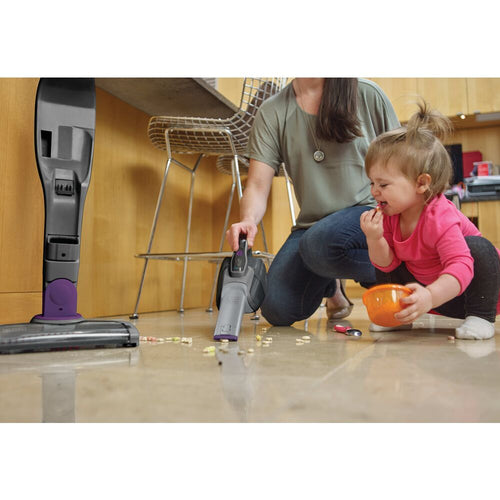 BLACK+DECKER POWERSERIES 2 in 1 Cordless Stick Vacuum being used to clean mess made by a toddler on the floor.
