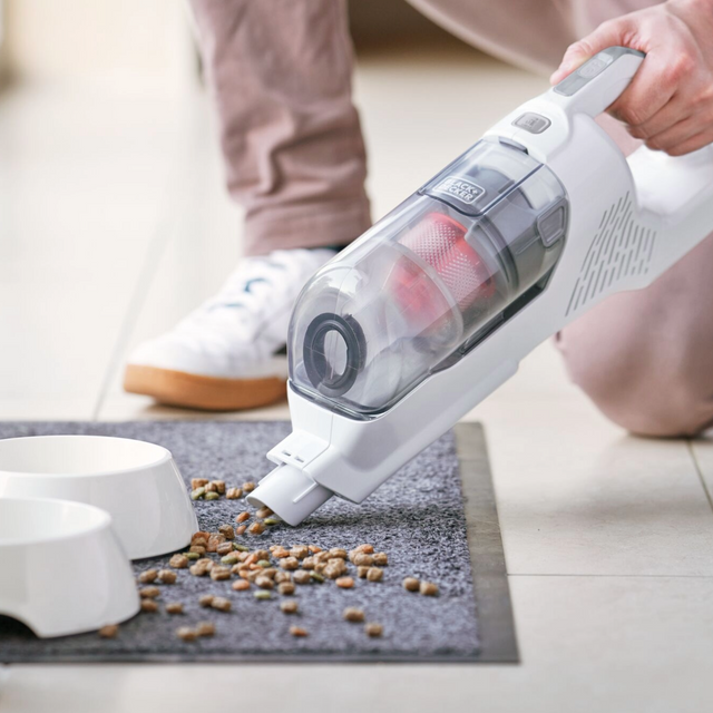 man using stick vac as handheld unit