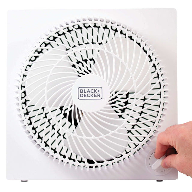 Hand turning 9 In. Frameless Tabletop Box Fan on with white background