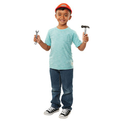 Young boy wearing BLACK+DECKER helmet while holding hammer and wrench toys.