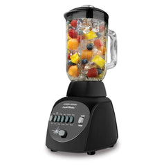 The BLACK+DECKER® Crush Master 10-Speed Blender with fruit and ice in blender pitcher on white background